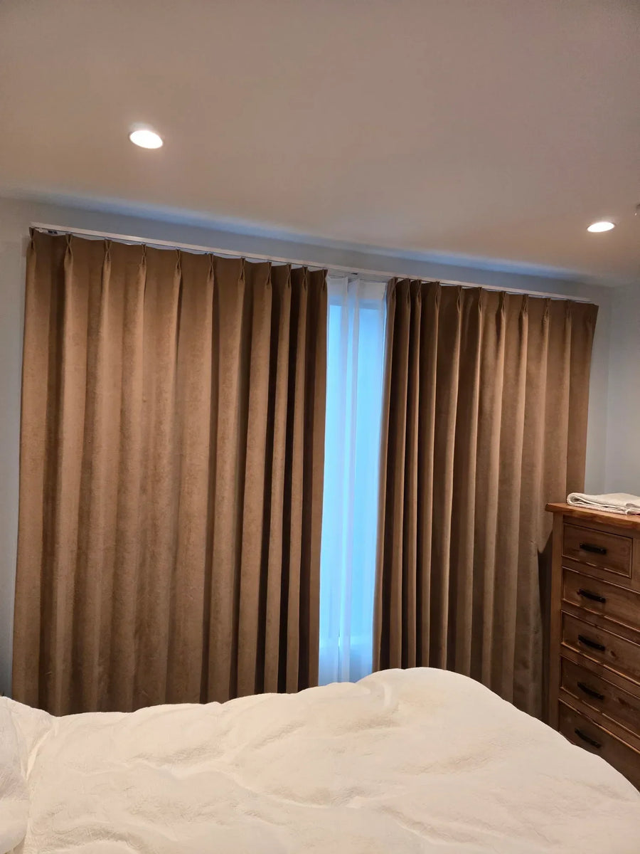 Warm brown double-pleat curtains installed in a St Johns Auckland bedroom